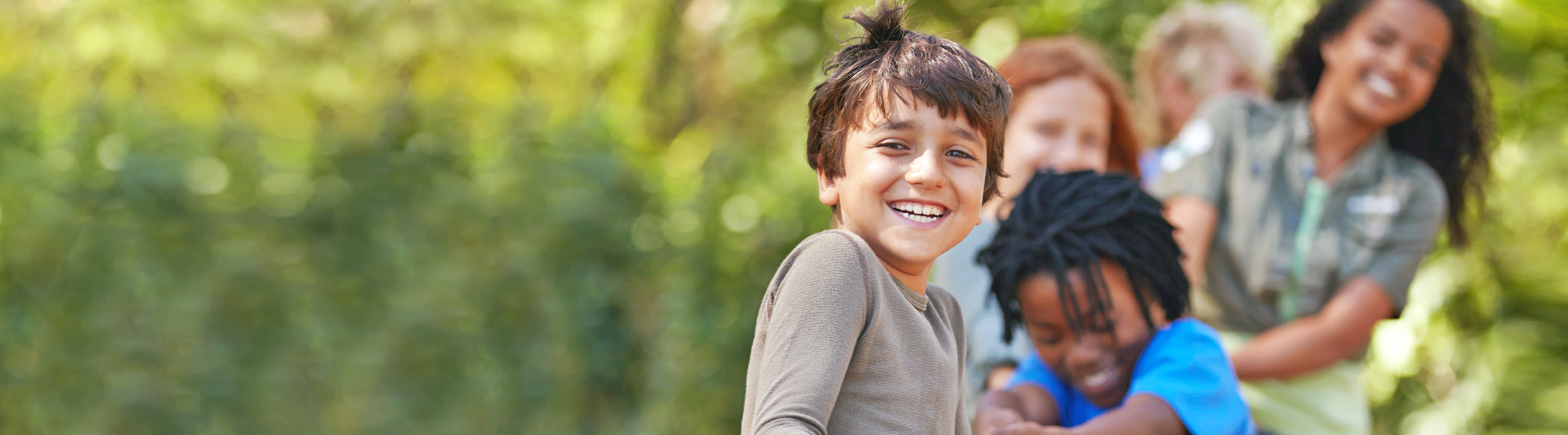 A group of kids in a tug-of-war game